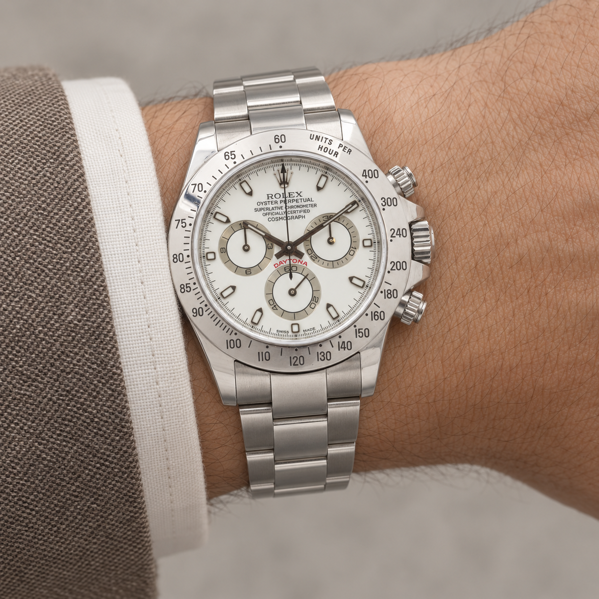 AI-generated reference illustration: Rolex Daytona 116520 white dial and steel bezel on wrist.