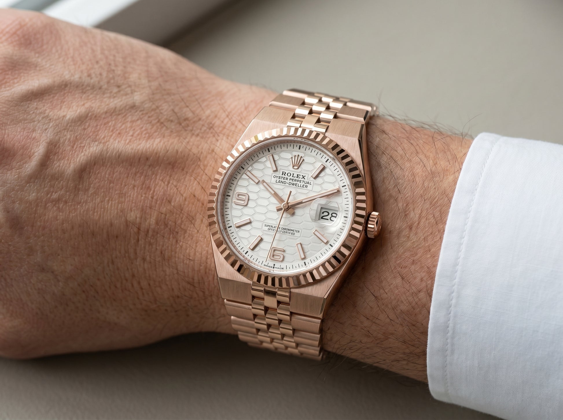 Rolex Land-Dweller 36 Rose Gold White Honeycomb Dial 127235 — lifestyle wrist close-up