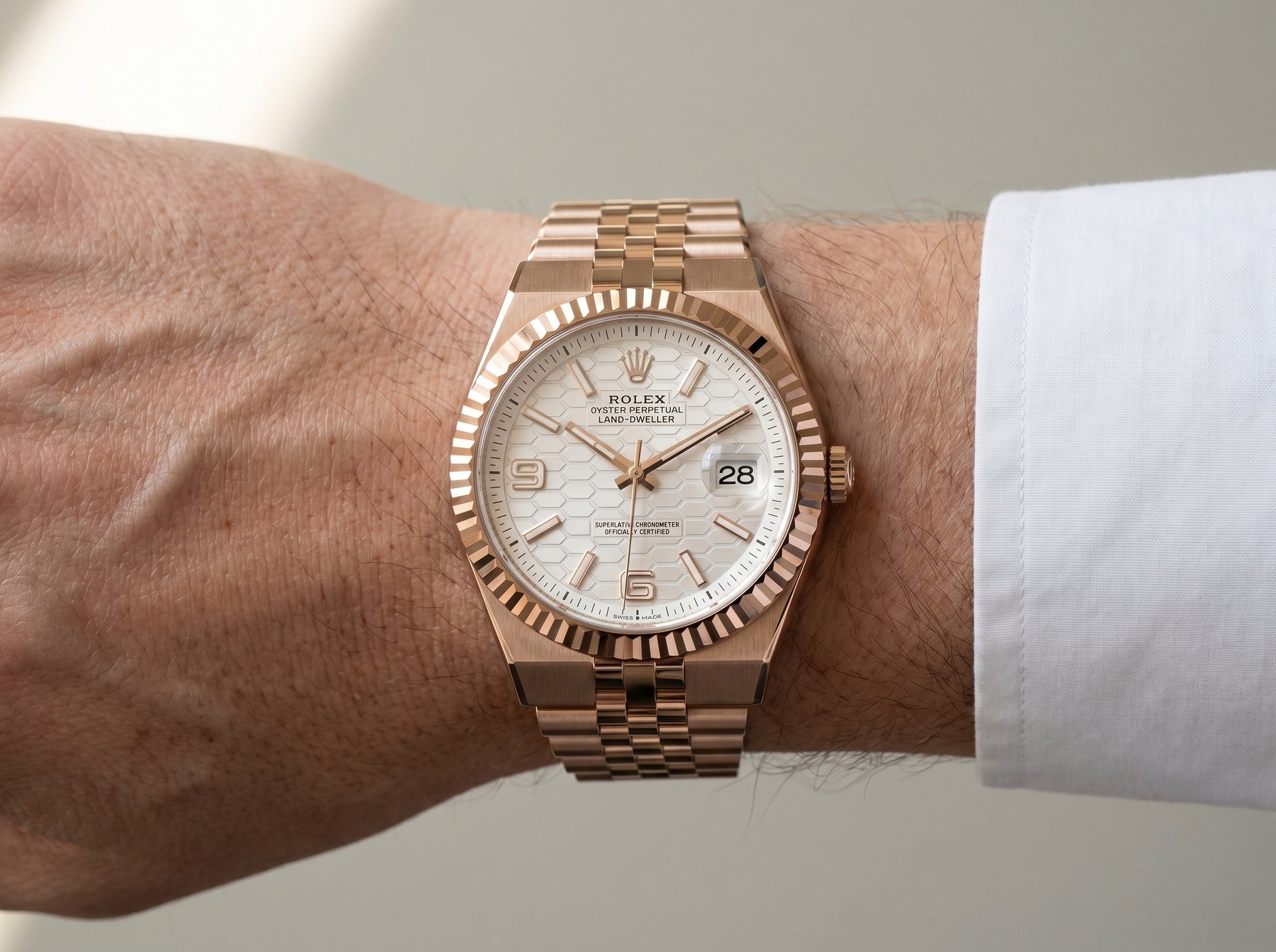 Rolex Land-Dweller 40 Rose Gold White Honeycomb Dial 127335 — lifestyle wrist close-up
